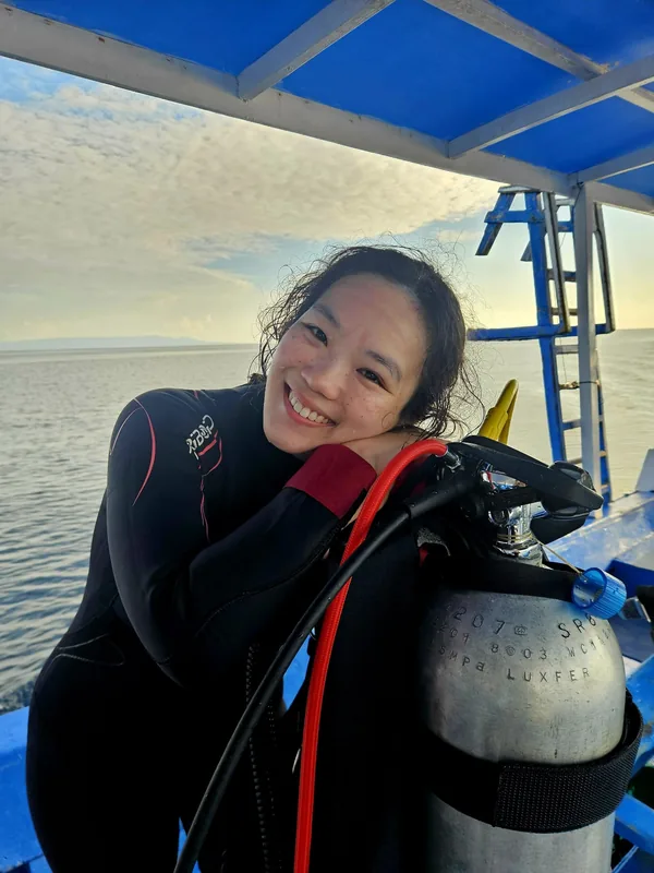 Abery in her wetsuit on a dive boat