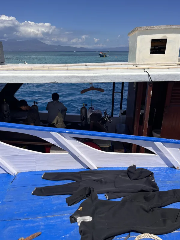 Wetsuits drying on the deck of a dive boat